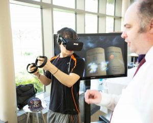 Photo of attendee at IU School of Informatics and Computing capstone event testing out VR. 