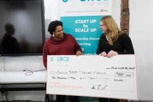 Photo of check being presented to winning entrepreneur. 