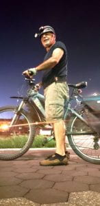 Photo of Manochehr Allaei riding his bike.