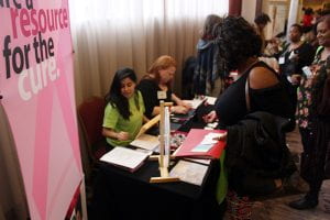 Photo of two young women at a table at a health fair. 